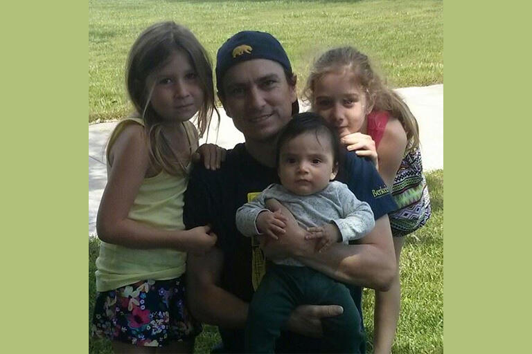 Joshua Kleinbergs and his three children at the park