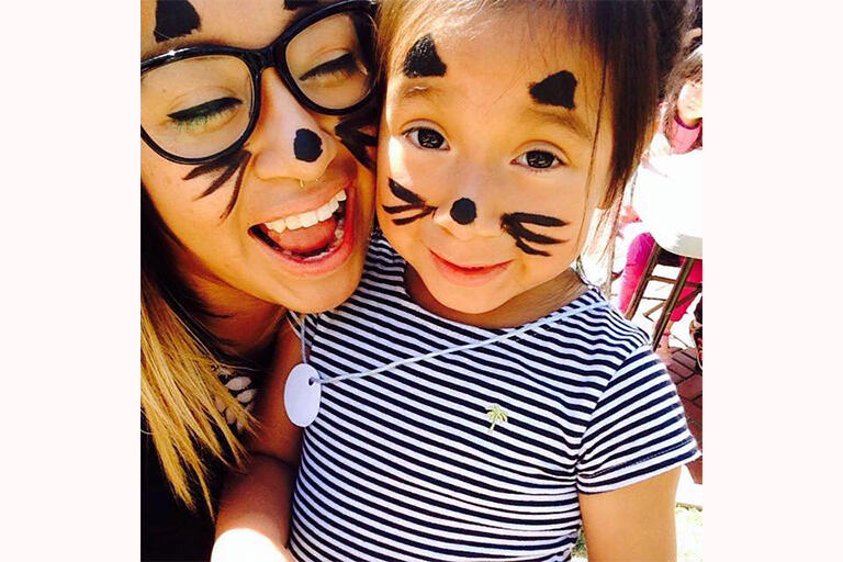Zuilma Garcia paint-facing with her daughter